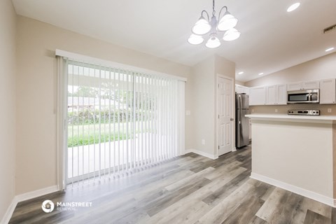 an open kitchen and living room with a large window