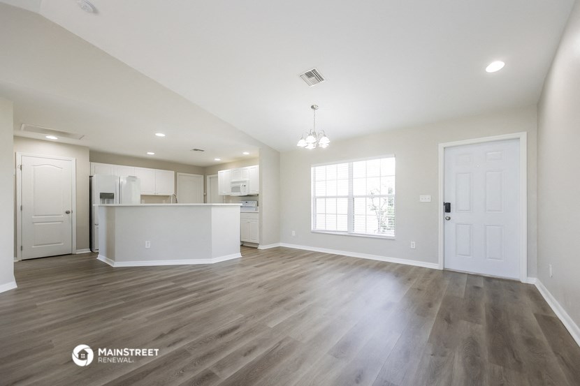 the living room and kitchen of a new home