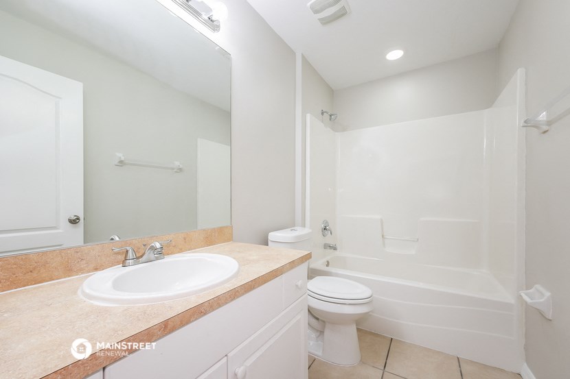 a bathroom with a sink and a toilet and a shower
