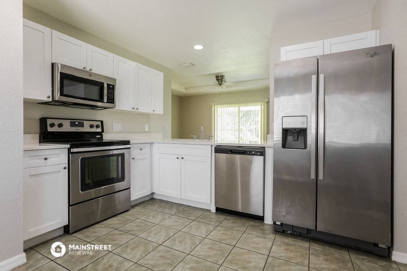 a kitchen with stainless steel appliances and white cabinets