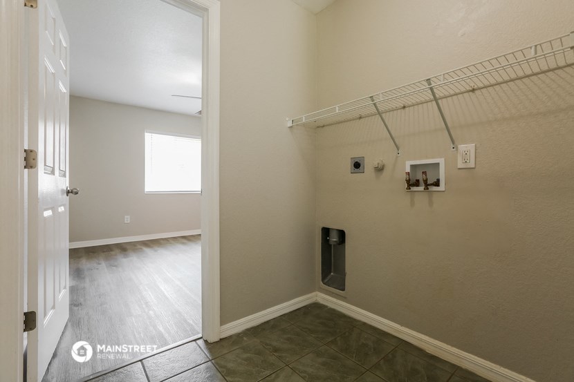 an empty room with a closet and a door to a bathroom