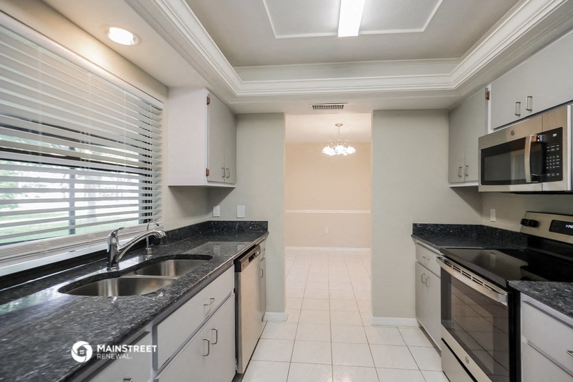 a kitchen with granite counter tops and a sink
