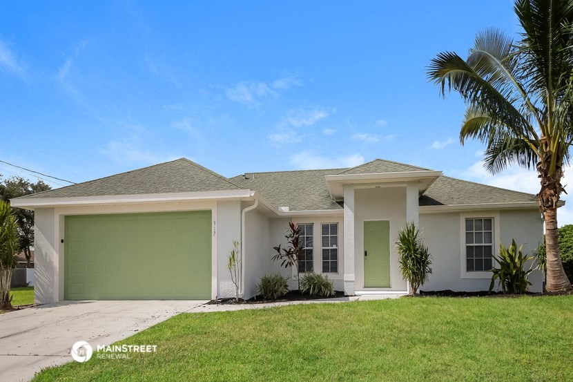 a white house with a palm tree in front of it