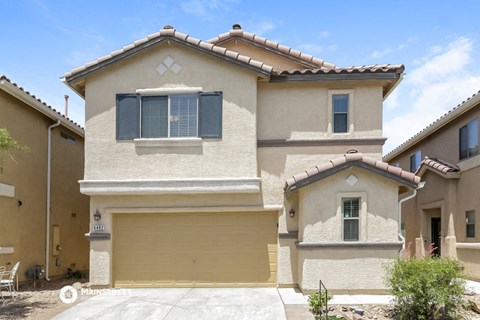 a beige house with a garage and a driveway
