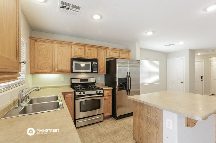 a kitchen with stainless steel appliances and wooden cabinets