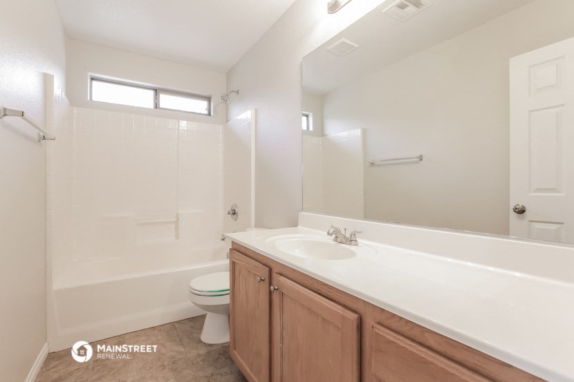 a bathroom with a white tub and a sink and a toilet