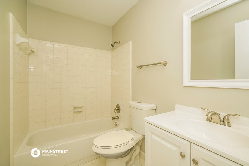 a bathroom with a sink toilet and a bath tub