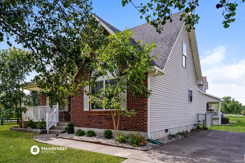 a white house with a tree in front of it