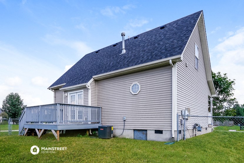 a view of the back of a house with a deck