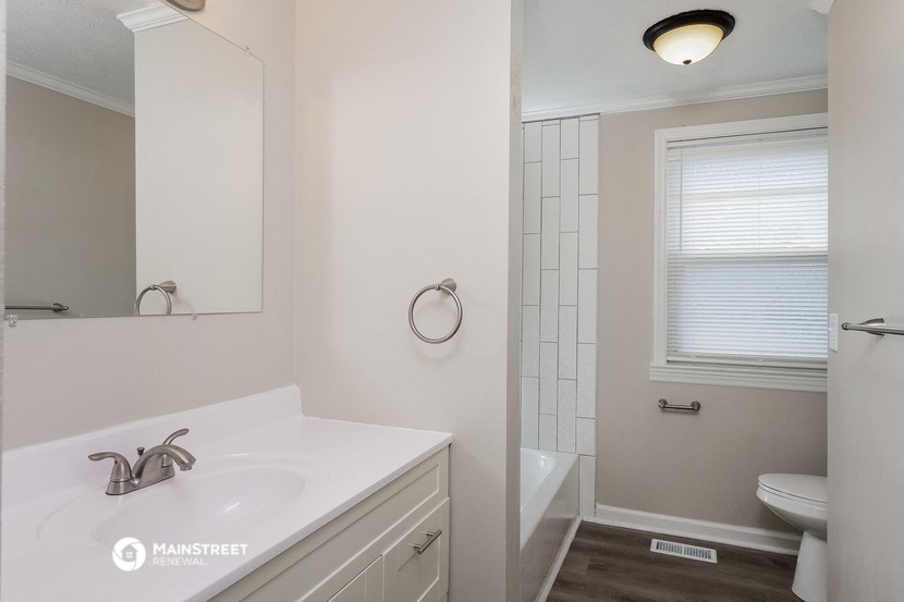 a bathroom with a sink and a toilet and a shower