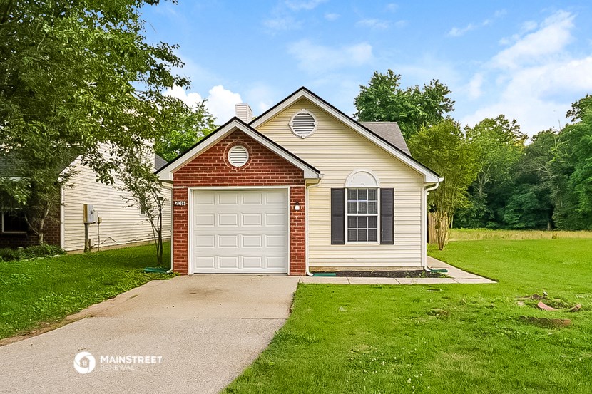 a house with a white garage door and a driveway