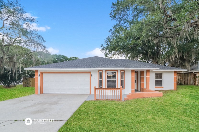 a home with a garage door and a driveway