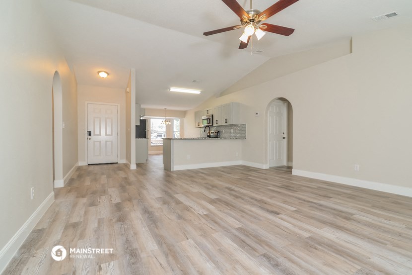 the living room and kitchen are open to the dining room