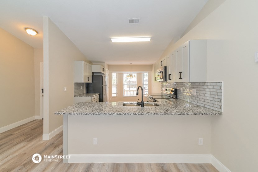 a kitchen with a granite counter top and a sink
