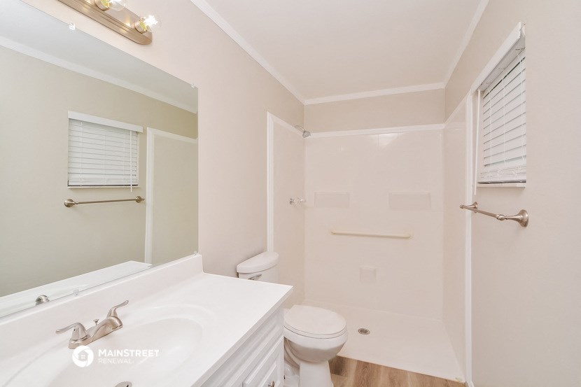 a bathroom with a sink toilet and a shower