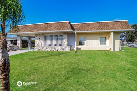 a house with a lawn and a palm tree
