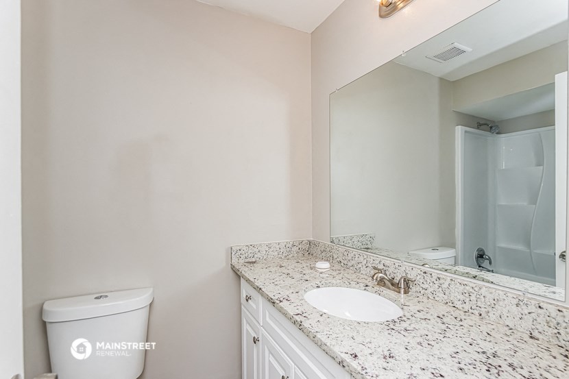 a bathroom with a sink and a mirror and a toilet