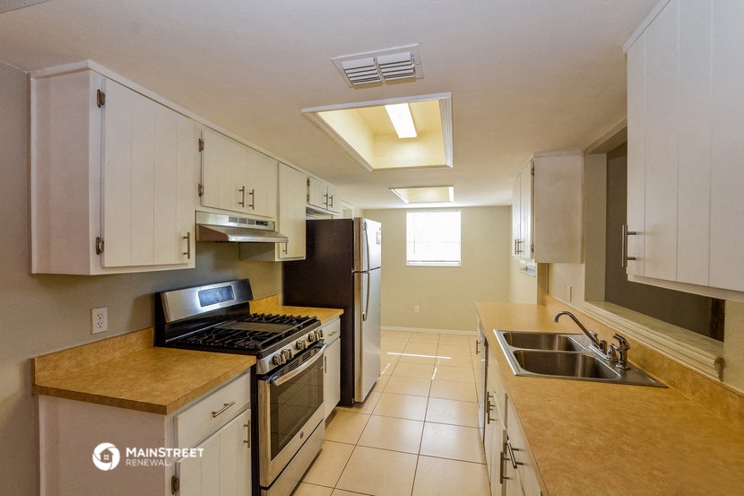 a kitchen with stainless steel appliances and white cabinets
