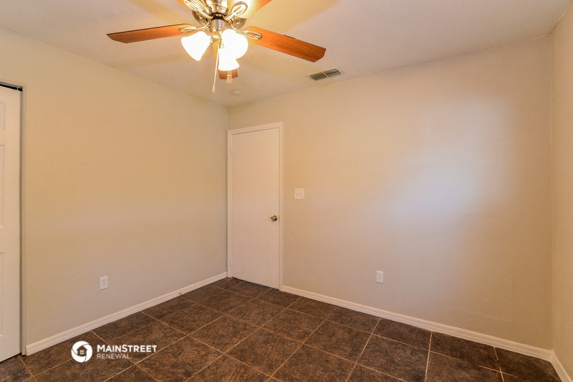 the living room of a house with a ceiling fan