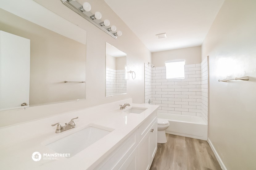 a bathroom with a sink and a shower and a toilet