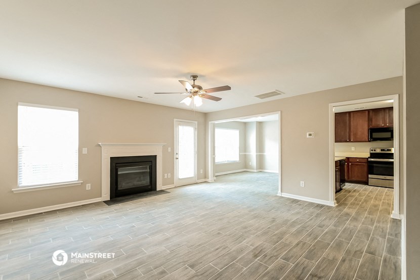 the living room of a new home with a fireplace