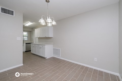 a kitchen with white cabinets and a white counter top