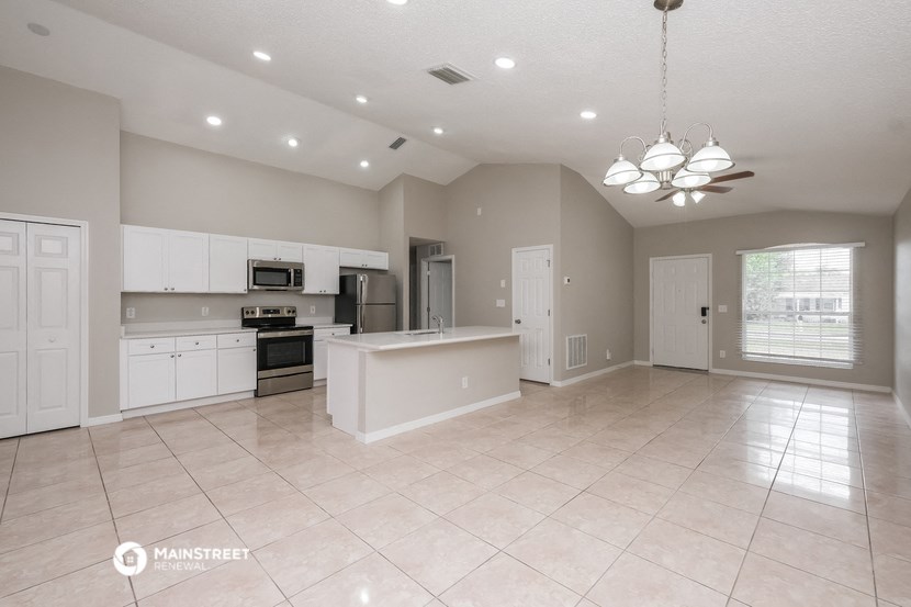 the kitchen and living room are spacious and clean