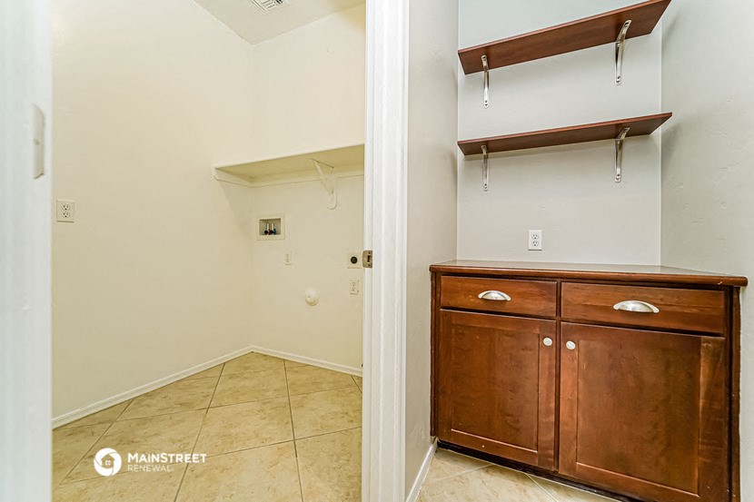 an empty room with a closet and a dresser and a door to a bathroom