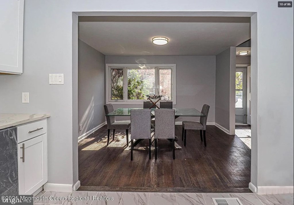 A dining room with a table set for four.