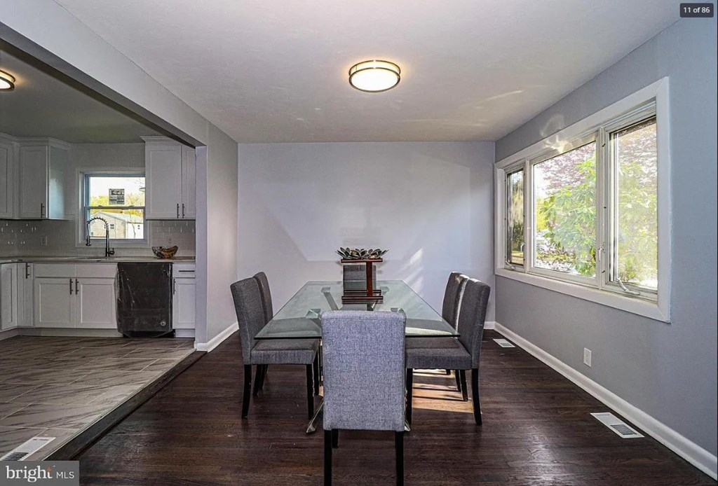 A dining room with a table set for four.