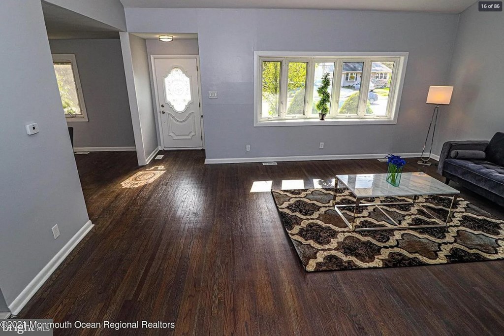 A living room with a rug and a couch.