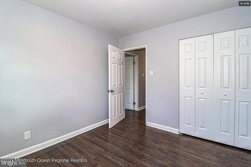 A room with a white door and a white cabinet.