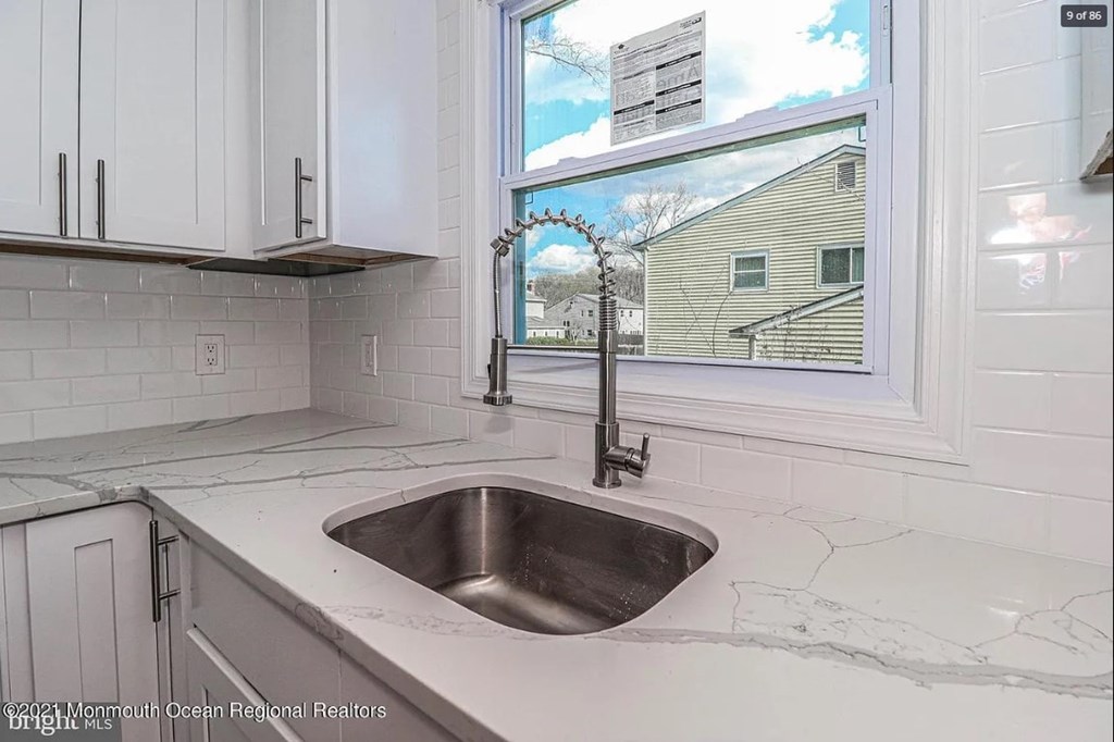 A kitchen with a sink and a window.