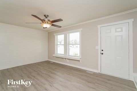 a bedroom with a ceiling fan and a white door