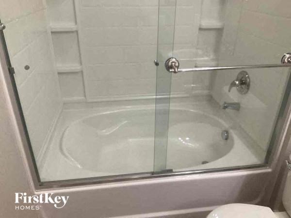 a bathroom with a glass shower and a toilet