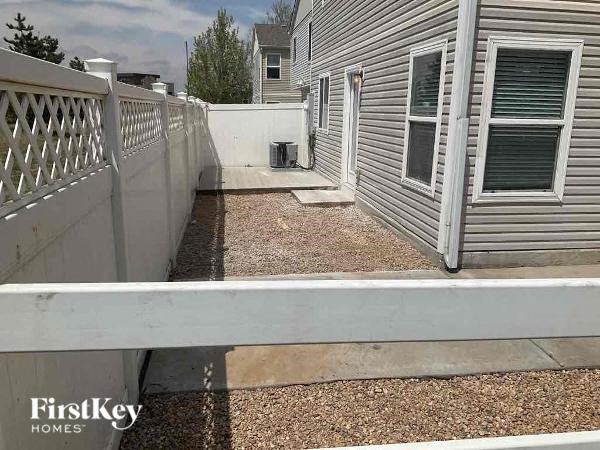 a white fence in front of a house