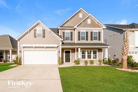 a house with a garage door and a lawn