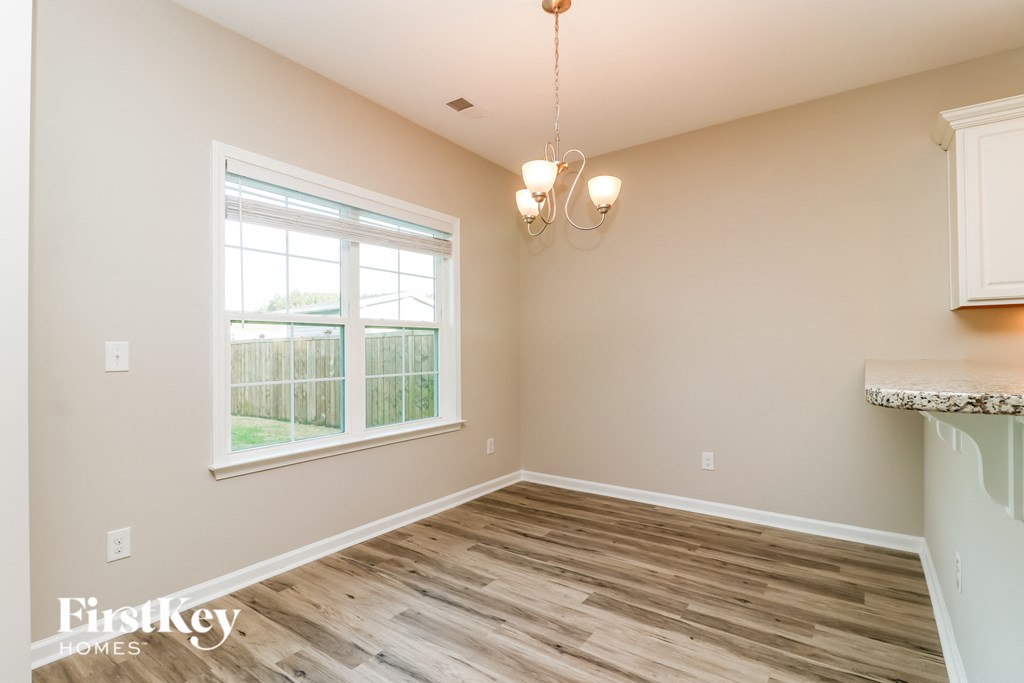 a living room with wood floors and a window