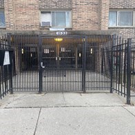 a black wrought iron gate in front of a building