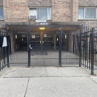 a black wrought iron gate in front of a building