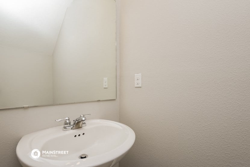 a bathroom with a sink and a mirror