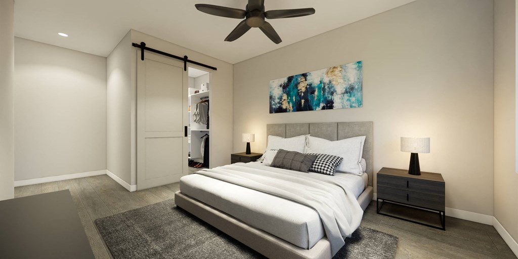 a bedroom with a white bed and a ceiling fan