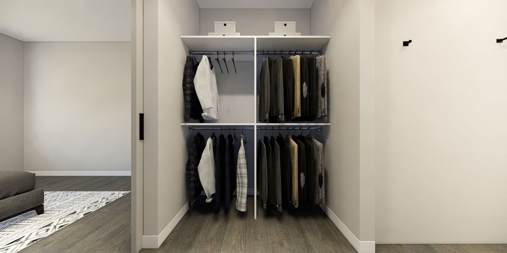 a closet with a rack of clothes in it