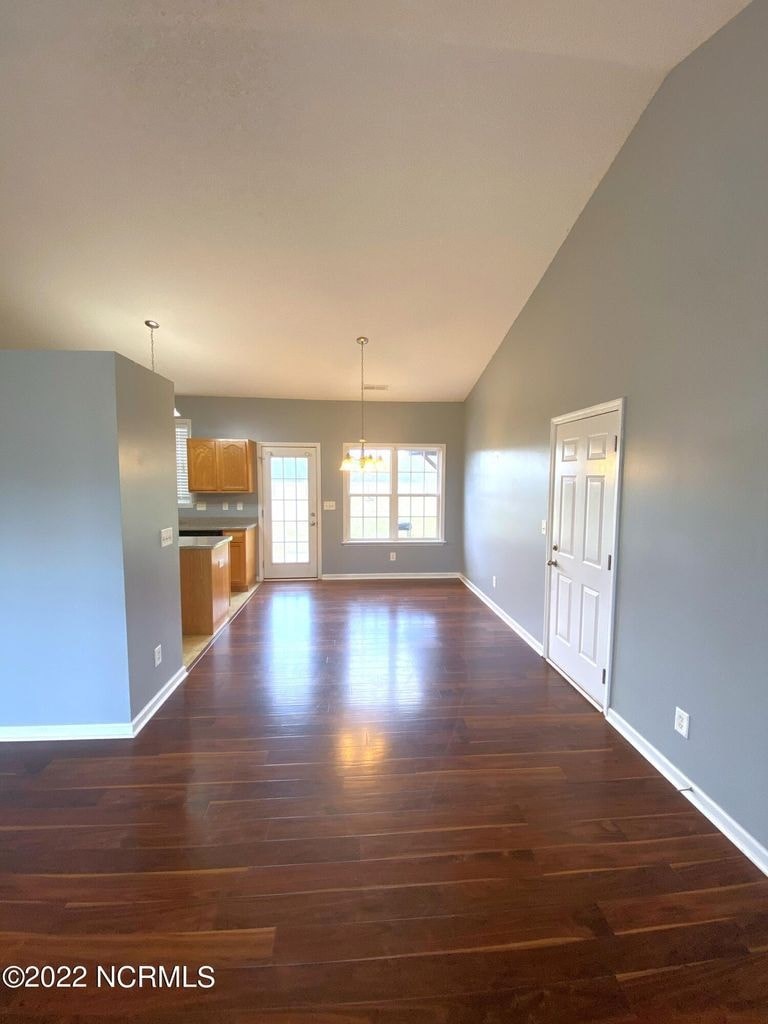A room with wooden floors and white walls.