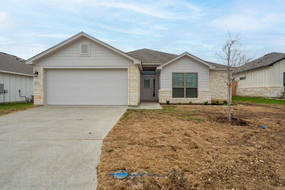 a house with a driveway and a garage door