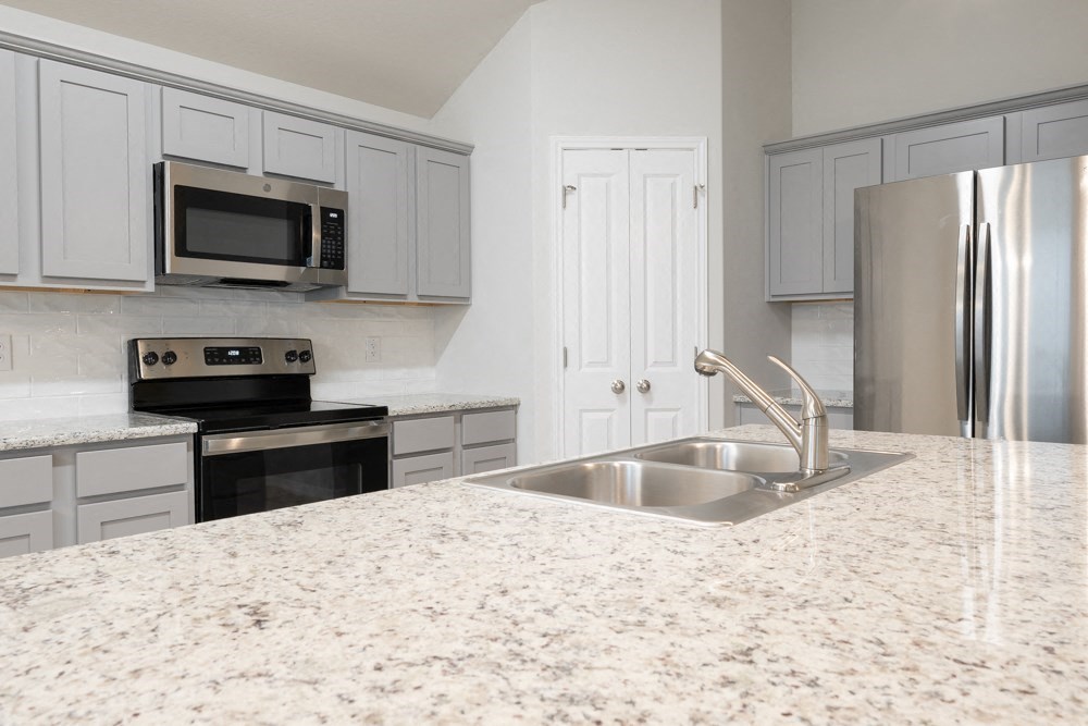 a kitchen with granite counter tops and a sink