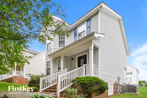 a white house with a porch and stairs