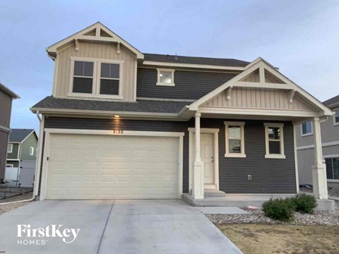 A two-story house with a garage is for sale.