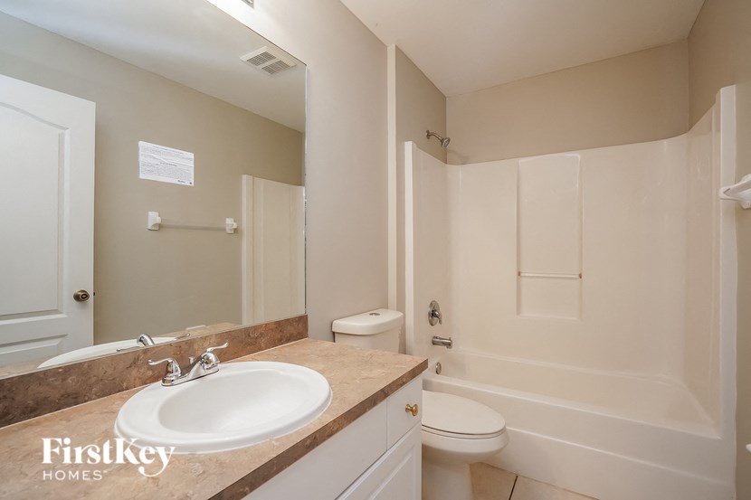 a bathroom with a sink and a toilet and a shower