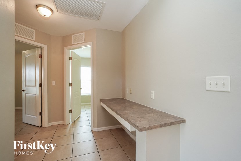 a hallway with a marble bench and a door to a bathroom